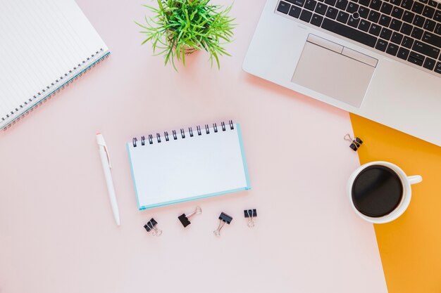 Stationery near laptop and coffee cup