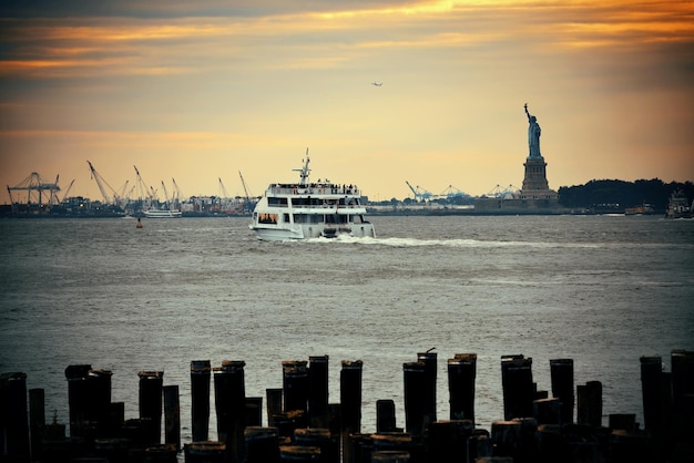 Statue of Liberty at New York City harbor with pier.