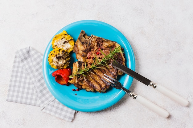 Free Photo steak with vegetables on plate with cutlery