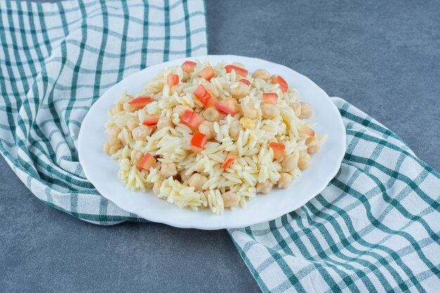 Free Photo steamed rice with peas and tomato slices on white plate. 