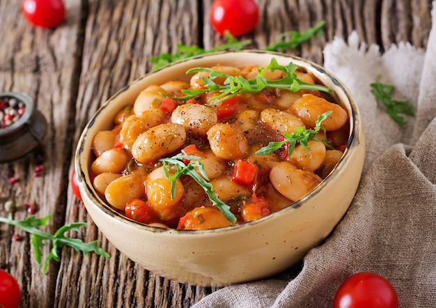 Steamed white beans with vegetables in tomato sauce. Vegan food. Asian meal.