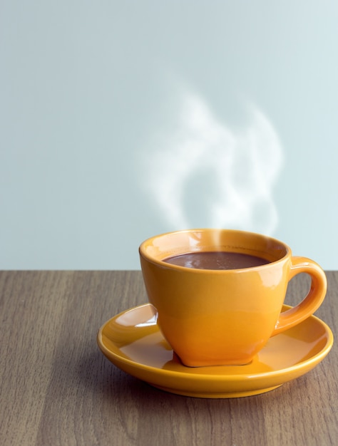 Free Photo steaming coffee cup on table