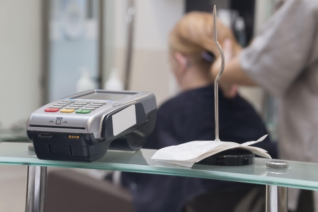 Steel check spindle and credit card terminal for receiving payments in the beauty salon