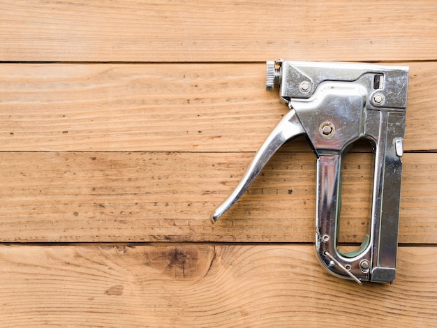 Free Photo steel staple gun on table