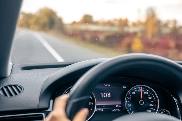 Steering wheel in a car close up high speed driving on the road