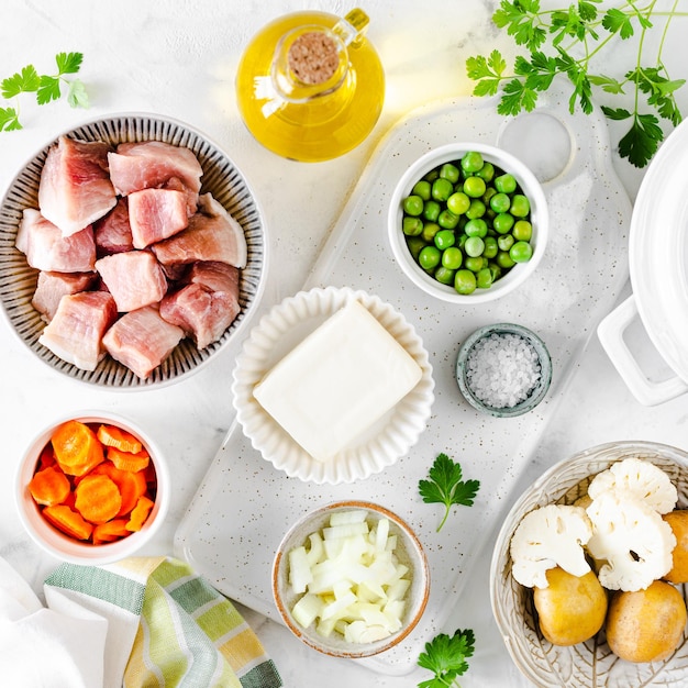 Step 1 Recipe for soup with meatballs cauliflower baby peas carrots and cream on a white background Square