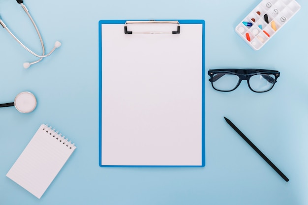 Stethoscope and glasses near clipboard