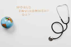 Free photo stethoscope and globe with word environment day text