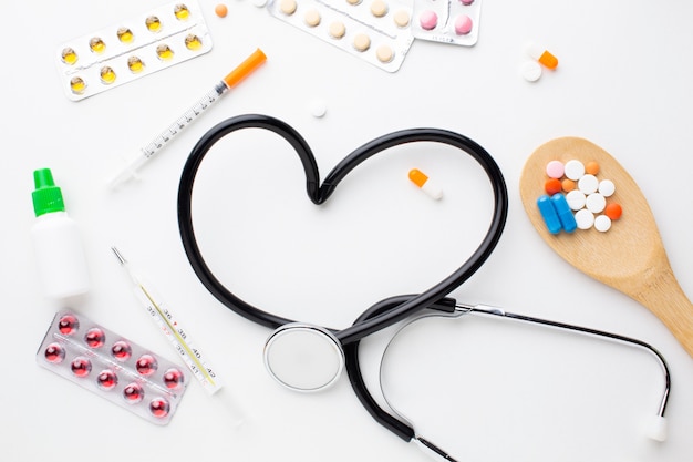 Stethoscope and medical pills with syringe