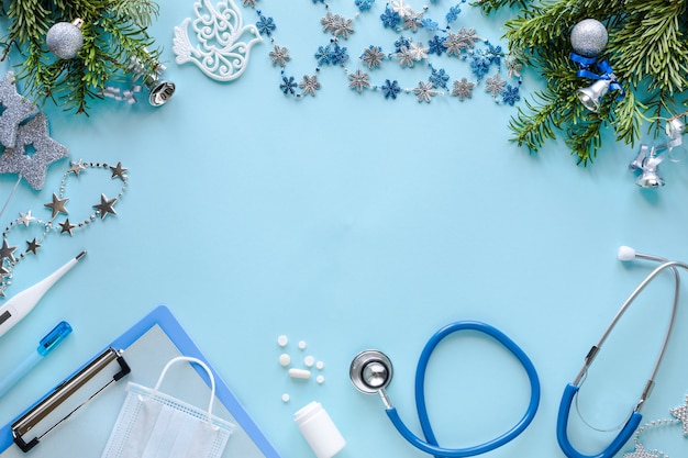 Stethoscope, thermometer, blank clipboard and Christmas decorations