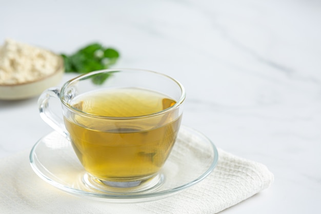 Stevia tea in a glass cup on the table