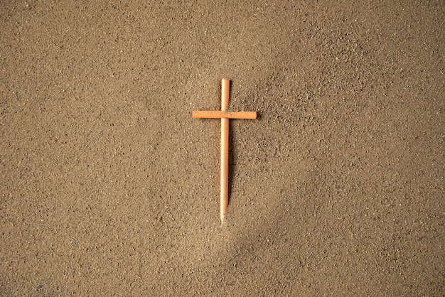 Stick cross on the sand