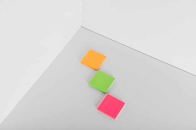 Free photo sticky notes in different colors in corner of room