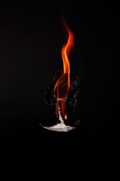 Free photo still life of burnt paper with flames