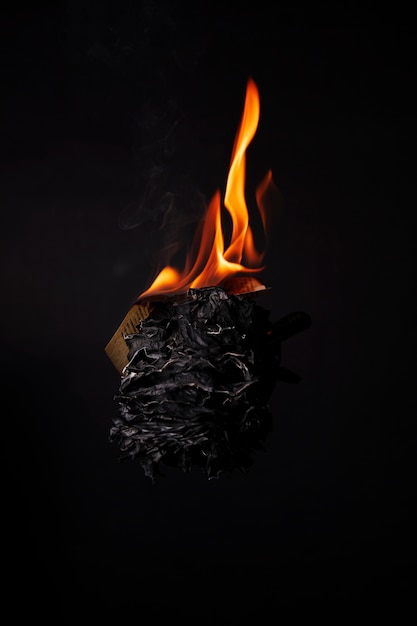 Still life of burnt paper with flames