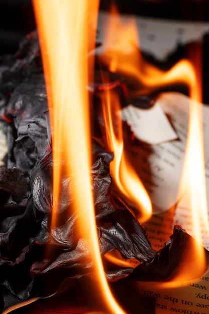 Free photo still life of burnt paper with flames