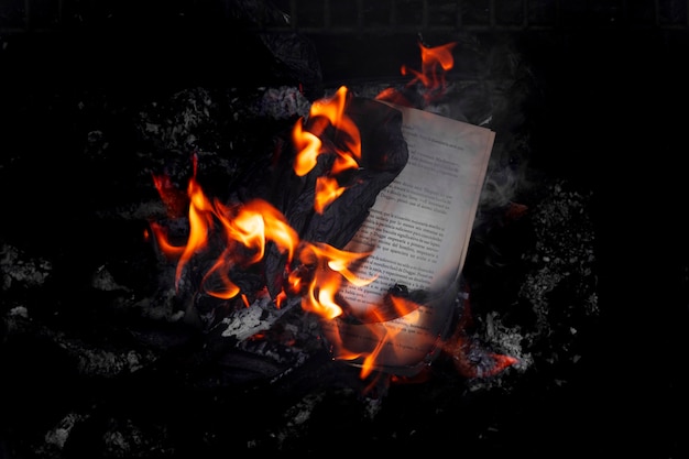 Free photo still life of burnt paper with flames