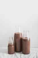 Free photo still life of chocolate milkshake bottle against white background