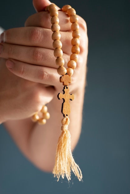 Free photo still life of crucifix held in hand