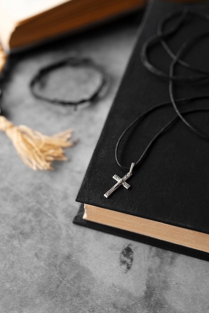 Free Photo still life of crucifix with book