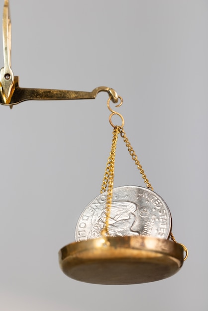 Free photo still life of dollar coins in scale