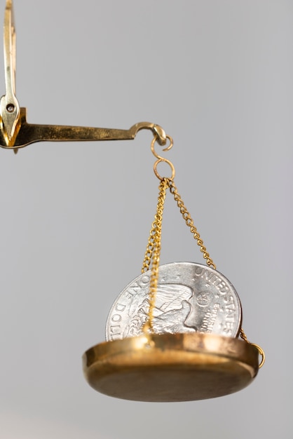 Free Photo still life of dollar coins in scale