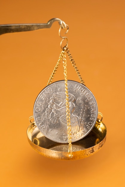 Free Photo still life of dollar coins in scale