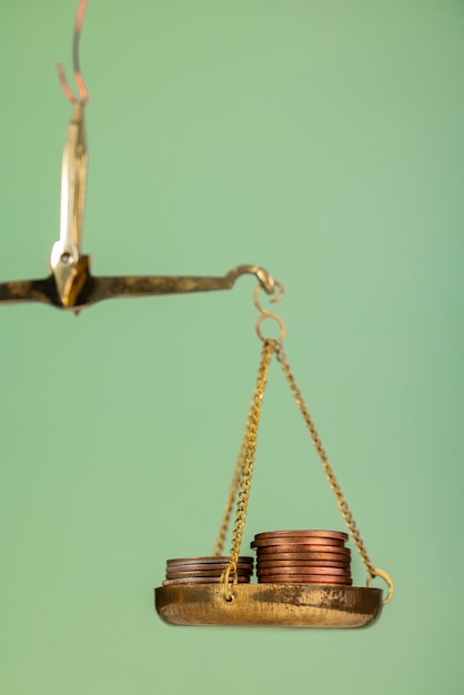 Free Photo still life of dollar coins in scale