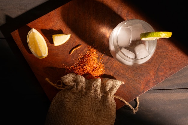 Free photo still life of mezcal drink with maguey worm