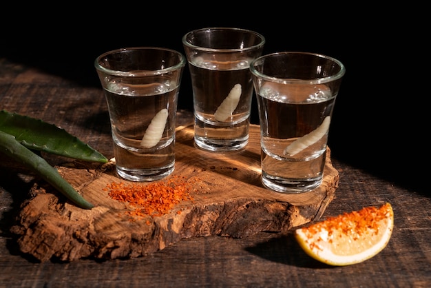 Still life of mezcal drink with maguey worm