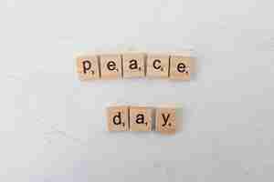 Free photo still life peace day wooden message arrangement