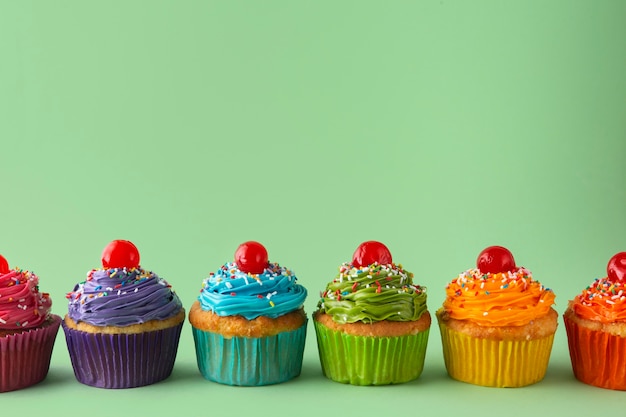 Free Photo still life of rainbow cupcakes