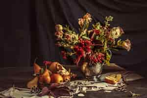 Free photo still life with apples and autumn flowers