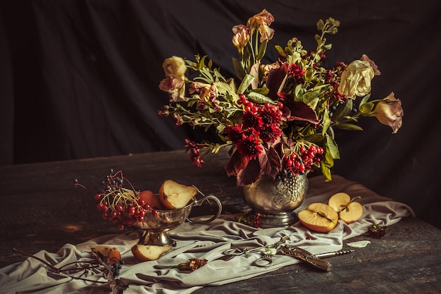 Free photo still life with apples and autumn flowers