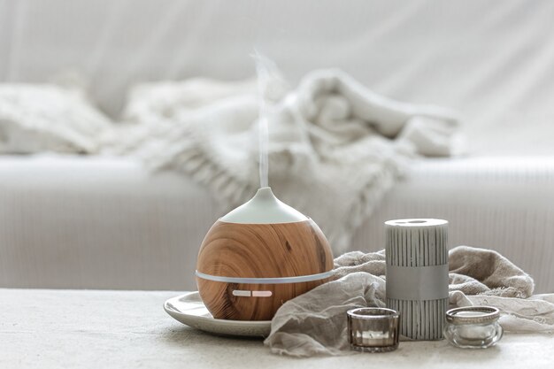 Still life with an aroma diffuser to humidify the air and interior decor details in a Scandinavian style.