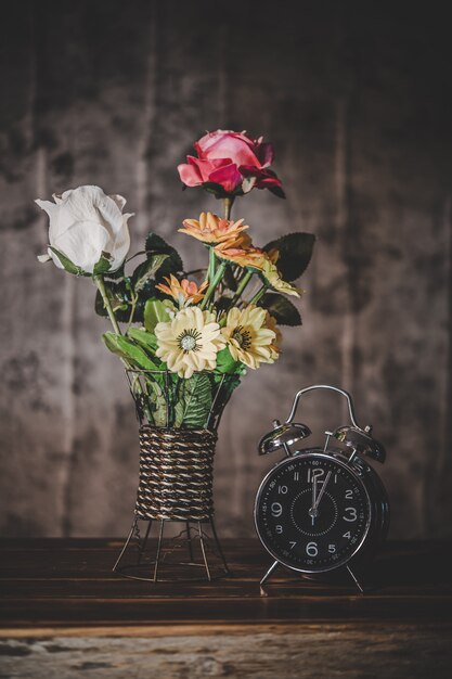 Still life with flower vases and clocks