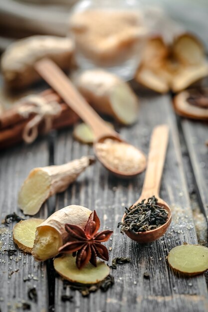 Still life with a ginger and lemon with sugar on wooden background