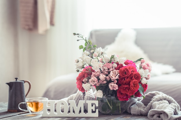 Free Photo still life with an inscription home and a vase of flowers