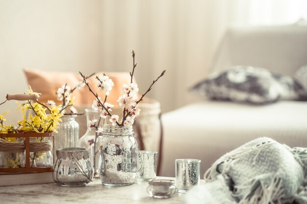 Still life with vases with spring flowers in the living room