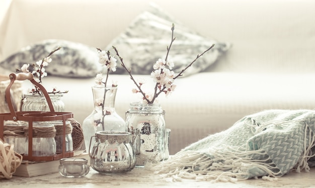 Still life with vases with spring flowers in the living room