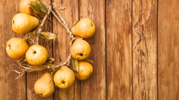 Still life with yellow pears on plywood wall