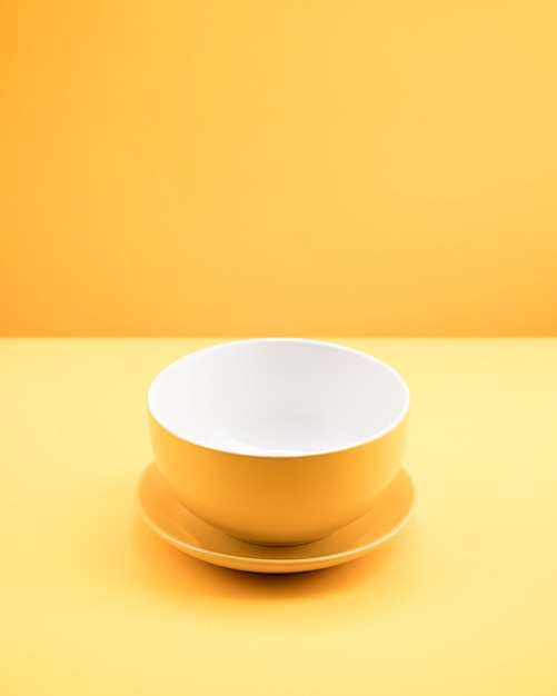 Free Photo still life of yellow cup