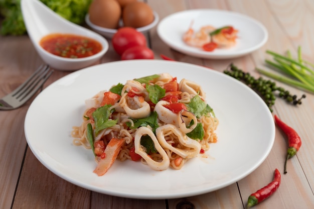 Stir-fried noodles with ink in a white plate.