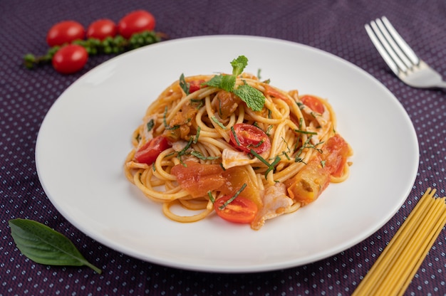 Stir-fried spaghetti beautifully arranged in a white plate.