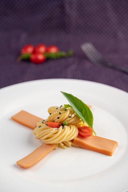 Stir-fried spaghetti beautifully arranged in a white plate.