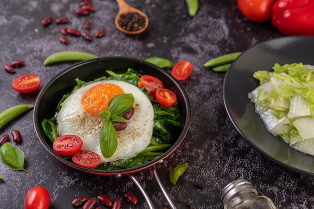 Stir kale and fried egg in a pan.