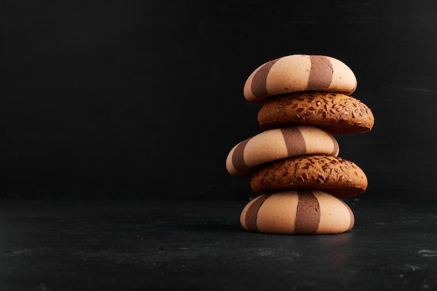 A stock of oatmeal and cocoa cookies, profile view. 