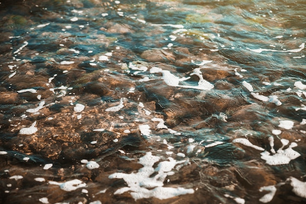 Stones under waving water 