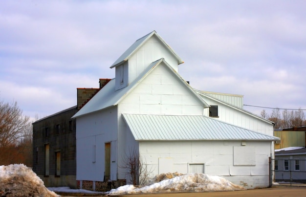 Free Photo storage house with a cloudy blue sky in the background