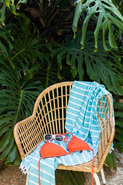 Free photo straw chair and swimsuit arrangement